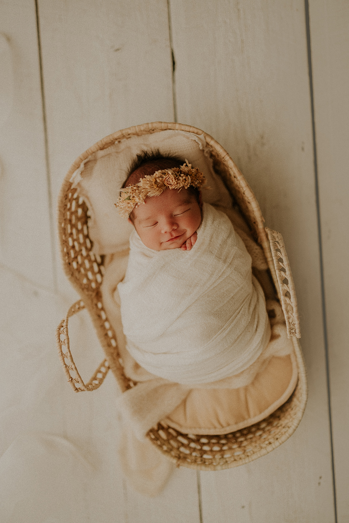 boho newborn girl swaddled in basket