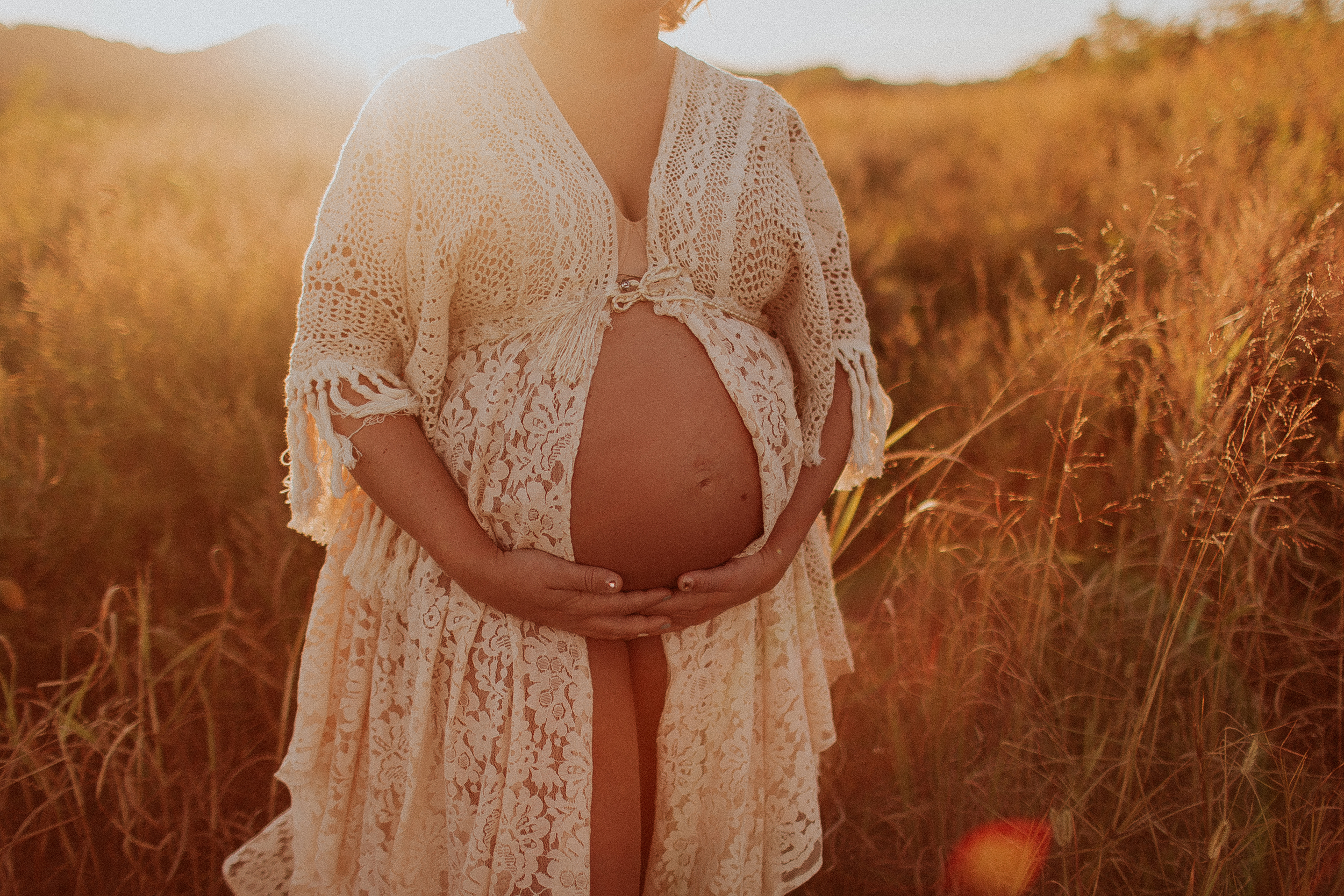 expecting mother in boho dress at sunset