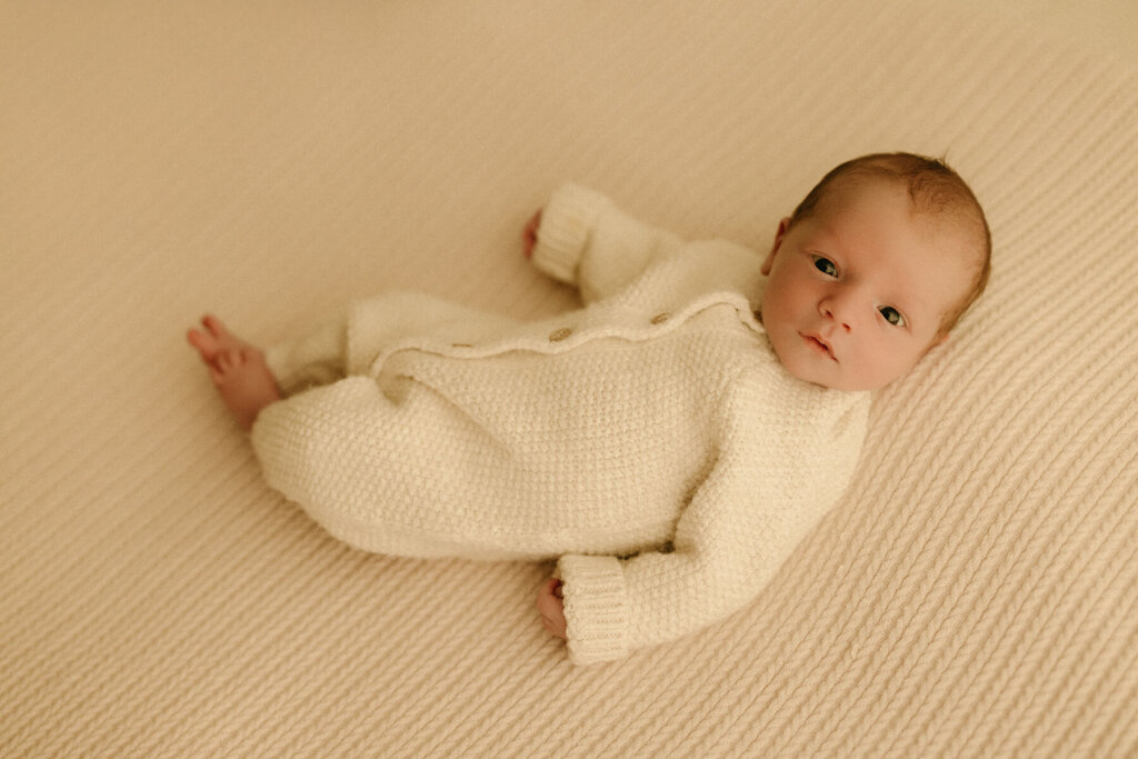 Rylan's Riches photography a Nashville Newborn Photographer photographing a newborn wide eyes looking at the camera
