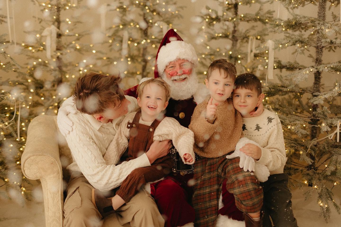 Family posing with Santa Claus during a Christmas mini session in Nashville, TN.
